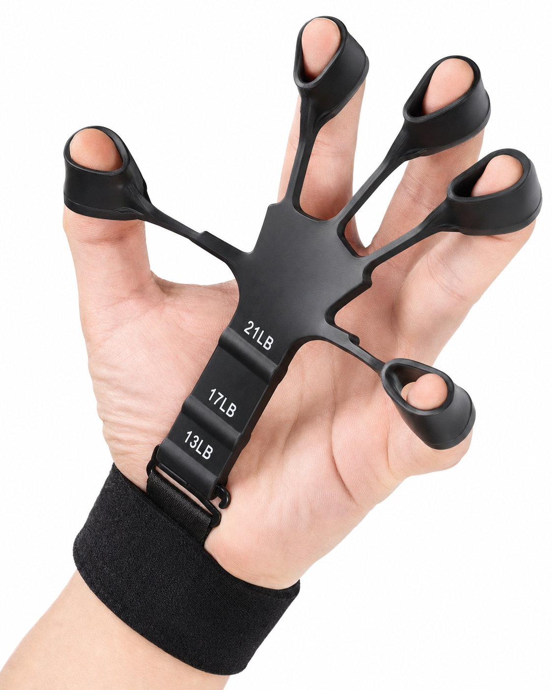 Hand wearing the black X-Grip Extensor — all five fingers through the ring openings and the velcro wrist strap fastened, showing how the finger extensor trainer is worn