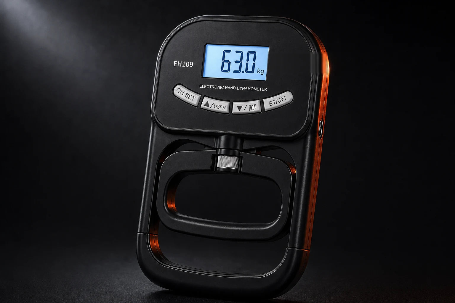 X-Grip PowerTester digital hand dynamometer on a dark studio background, LCD screen lit showing a grip-strength reading in kilograms