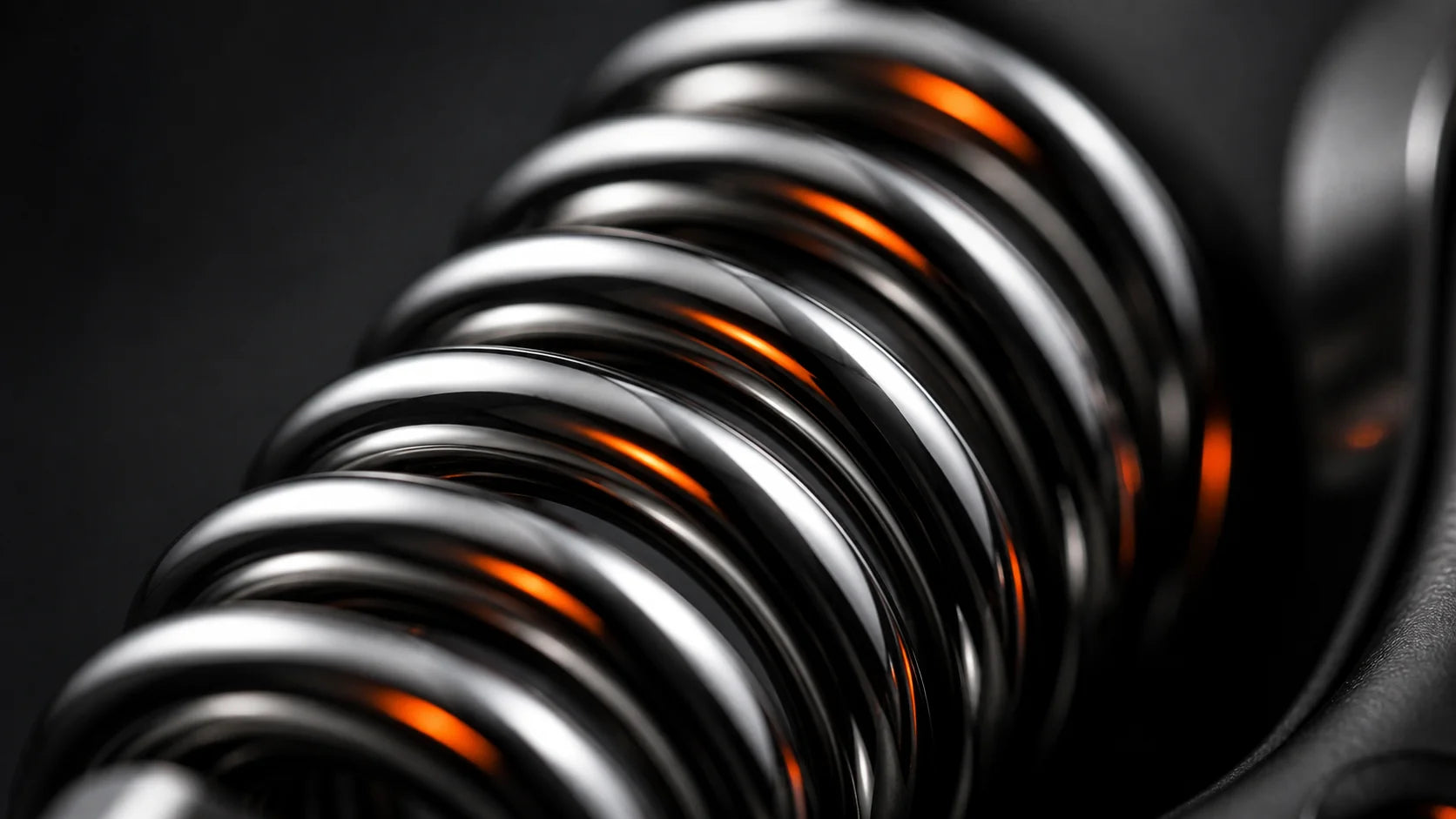Macro detail of the steel spring and resistance dial on the X-Grip Pro, showing the 5 to 100 kg adjustable mechanism