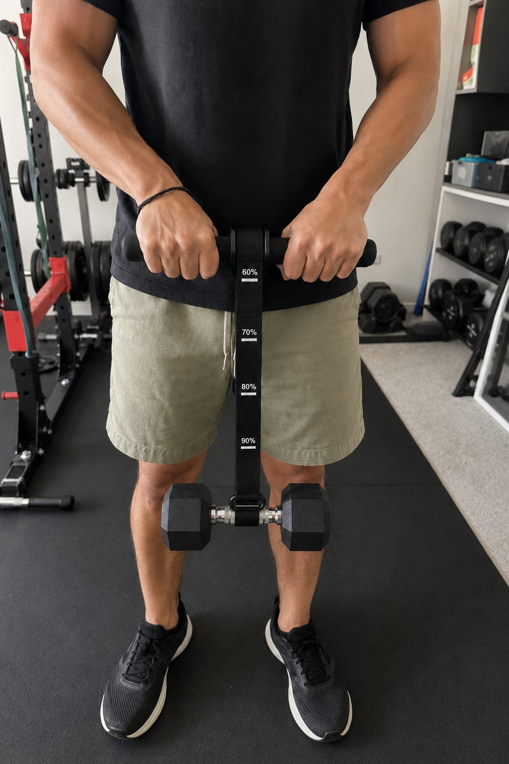 Man training wrists and forearms with the X-Grip Roller in a home gym, dumbbell hanging from the strap